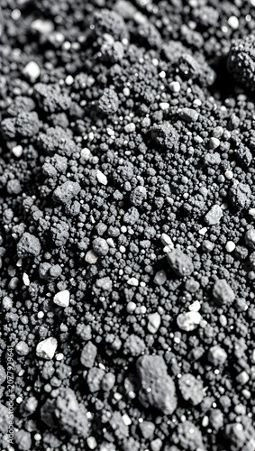 Close-up texture of small gray and black pebbles.