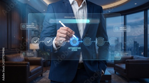 Business technology professional managing projects on a digital display in a contemporary office overlooking the city skyline during the workday to improve productivity and workflow.
