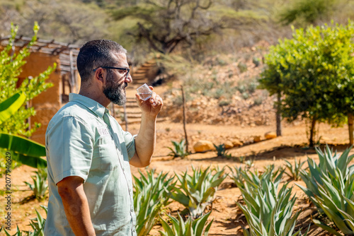 Artisan Distiller Evaluating Quality of Clear Agave Spirit