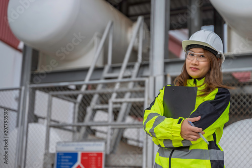 Engineer inspecting helium storage tanks at an industrial gas facility, supporting cryogenic storage management, operational monitoring, infrastructure reliability, safety compliance