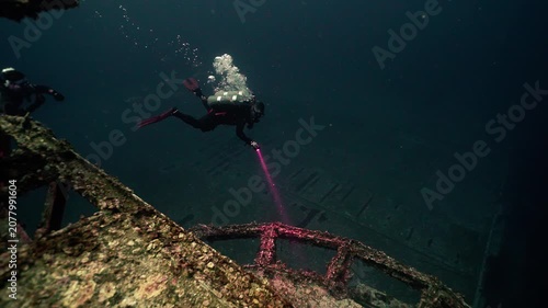 Technical Scuba Diver on Deep Dive Observing Sunken Shipwreck
