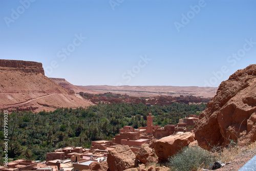 The lush green palm grove of the Tinghir oasis stretches out before the village of Ait-Boujane in Morocco.