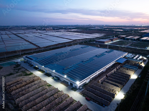 Large energy storage power station and timber yard at dusk captured by aerial photography
