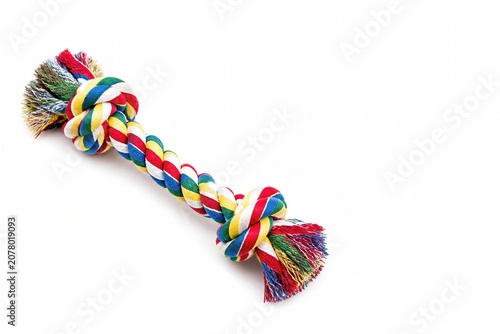 Multicolored rope toy knotted for dog chewing on white background