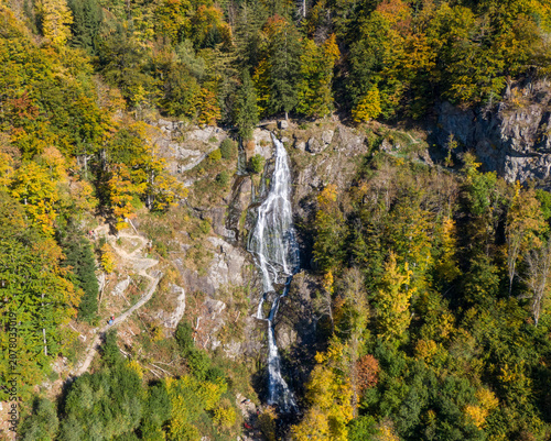 Aerial autumn view of Todtnau waterfall with yellow hills
