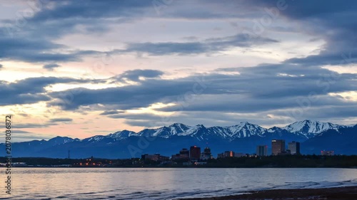 Scenic View of Anchorage Alaska City Skyline at Dusk with Snow-Capped Chugach Mountains and Cook Inlet Waterway