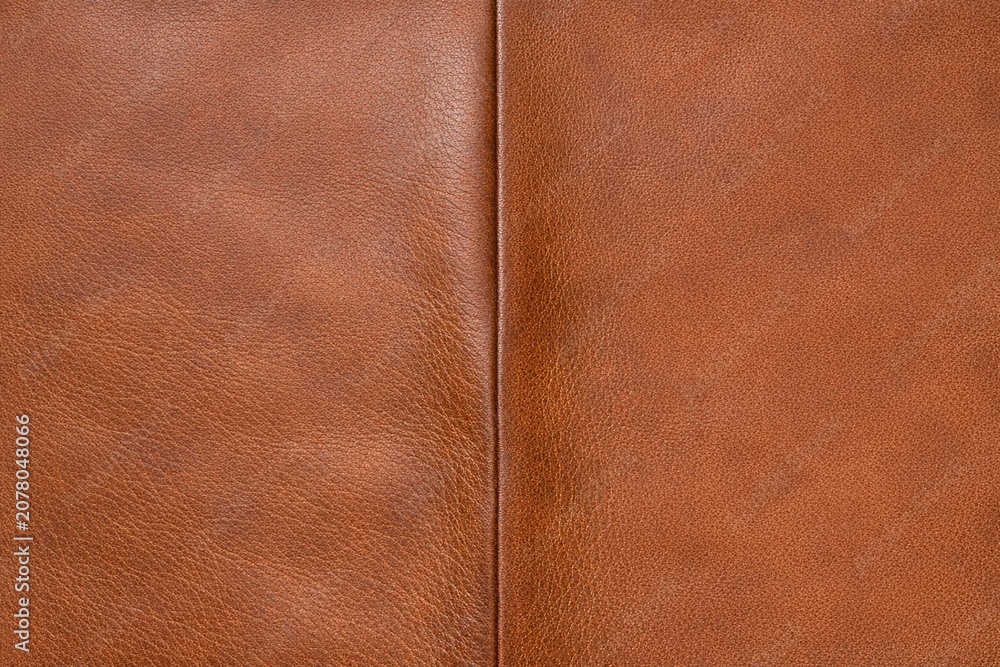Fototapeta premium A high-quality close-up image of a brown leather sofa, perfect for showcasing furniture design or interior decor