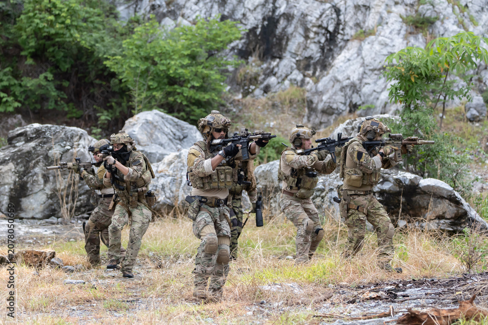 Fototapeta premium Military participate in a patrol in forrest terrain
