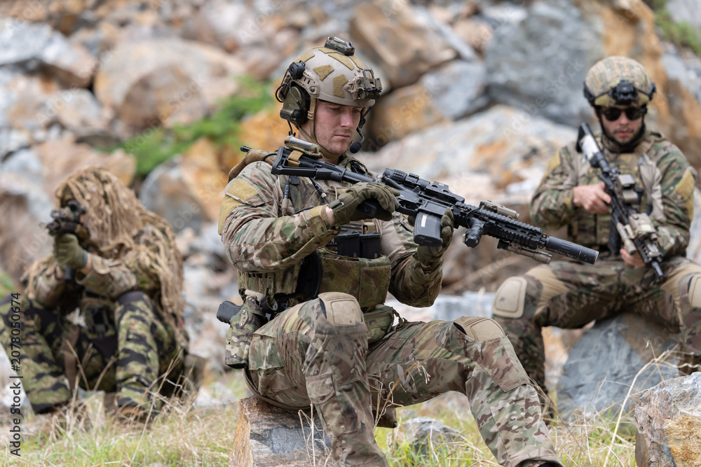 Fototapeta premium Soldier inspecting rifle during the mission