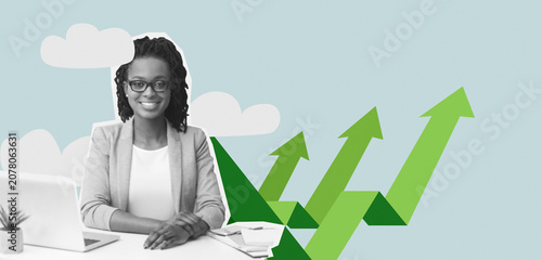 Bild auf Leinwand Focused Black Female Professional Working On Laptop At Desk In Modern Office Environment