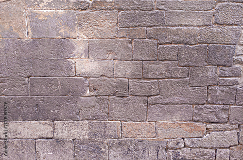 Ancient natural stone wall texture background old weathered surface