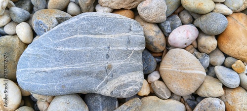Canvas Print Macro shot of smooth grey river stones background