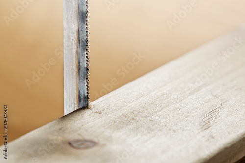 handsaw cut a wooden board. Carpentry and industry of construction.