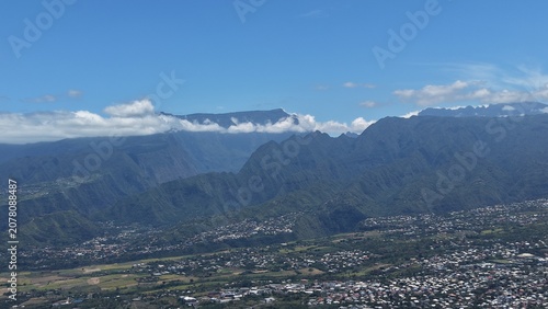 Tableau sur toile Aerial view of the town of Le Tampon sloping down to the coast, Reunion Island