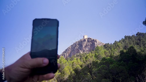 Recording a landscape video with the smartphone. in Cocentaina, Comunidad Valenciana, Spain.