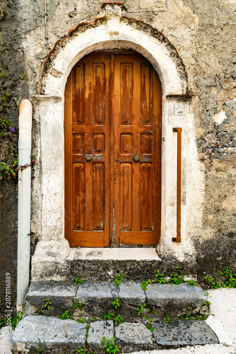 Vintage wooden front door in Calabria village