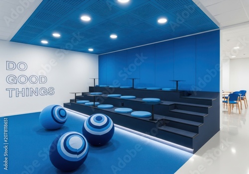 Minimalist blue office auditorium with stadium seating steps.