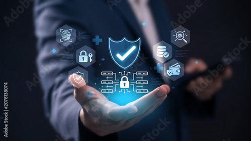 Businessman's hand projecting digital security icons and shield, representing data protection and cybersecurity.