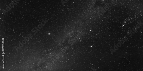 Bild auf Leinwand The breathtaking expanse of the night sky showcases a dense cluster of brilliant stars and the hazy, ethereal glow of the Milky Way galaxy, inspiring a profound sense of cosmic wonder
