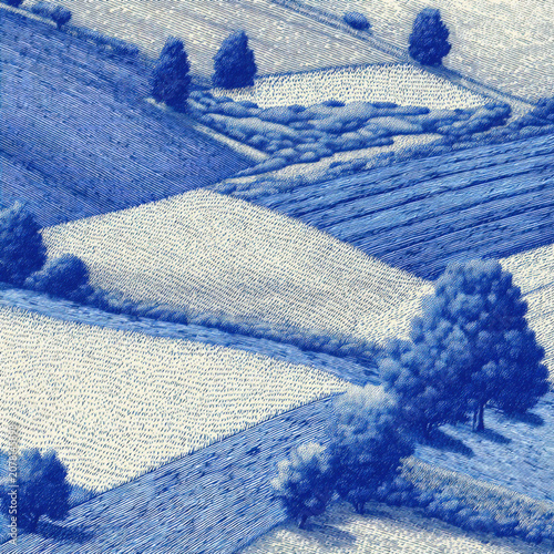 Fields with trees in blue shades on a clear day