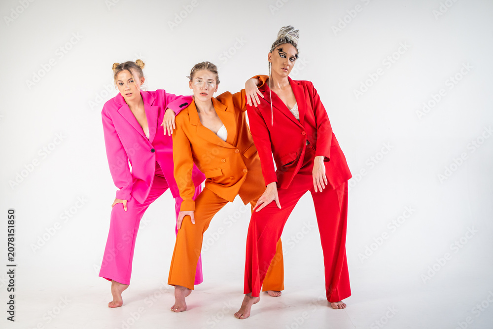 Naklejka premium Adult, sexy girls in white lingerie and bright jackets, posing in a studio against a white background