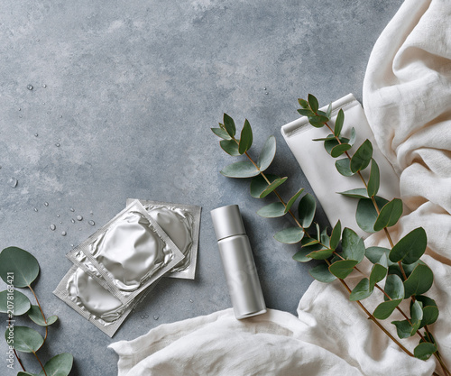 Minimal intimate care products with eucalyptus and linen on stone surface