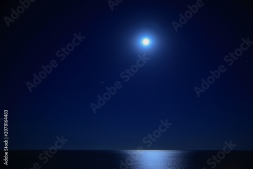 night sky with stars and moon over the sea