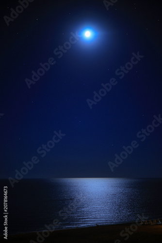 night sky with stars and moon over the sea
