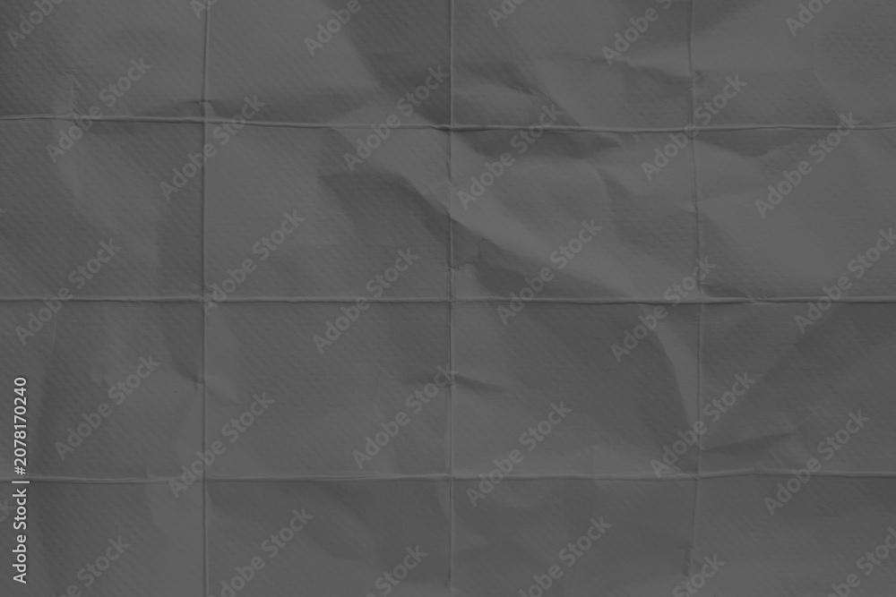 Obraz premium Dark gray crumpled paper texture background with folded grid