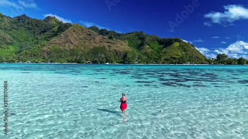 Woman snorkeling in a tropical turquoise lagoon in bora bora
