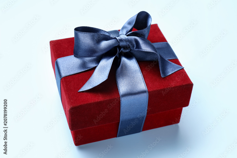 Fototapeta premium Beautiful velvet gift box on light blue background, closeup