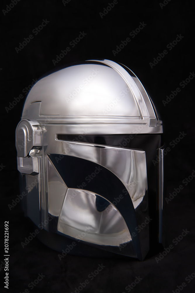 Obraz premium Professional photograph of a Mandalorean helmet on dark velvet, captured in El Salvador, Cinepolis on June 26, 2026.