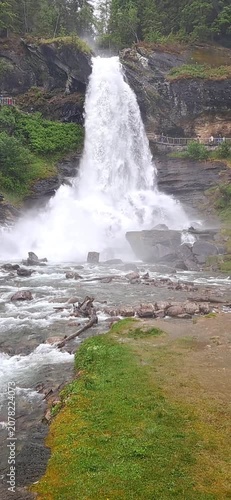 Steinsdalsfossen is a huge waterfall in Norway, making it possible to walk behind the curtain of water