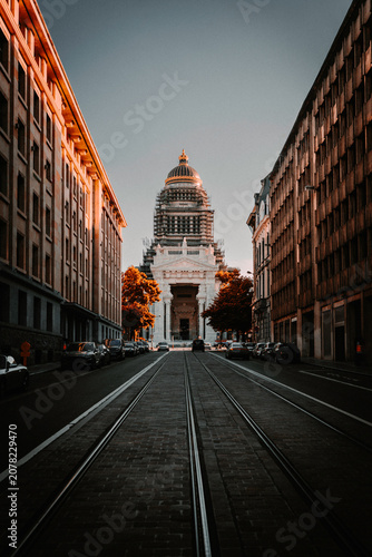 Symmetrical urban perspective looking down empty tram tracks toward the historic Palais de Justice dome, Brussels cityscape