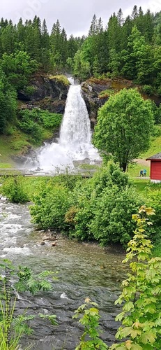 Steinsdalsfossen is a huge waterfall in Norway, making it possible to walk behind the curtain of water