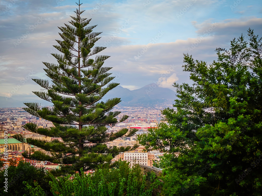 Fototapeta premium Aerial drone view of Naples old town panorama with Mount Vesuvius in background, scenic cityscape of historic center and iconic volcano view in Italy