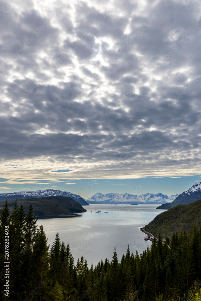 Obraz premium View over the Burfjord with the snow-covered peaks of the Lyngen Alps in the background in northern norway, troms county