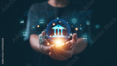 Digital banking and financial technology concept. Hands holding virtual bank icon with global network connections. Online banking, fintech innovation, secure financial services, digital payments.