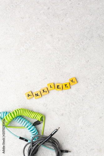 Top view of assorted charging cables surrounding wooden letter tiles spelling 