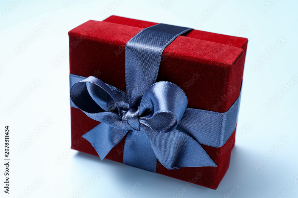 Fototapeta premium Beautiful velvet gift box on light blue background, closeup