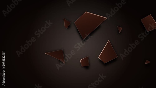 Dark chocolate pieces falling and scattering on a dark background.