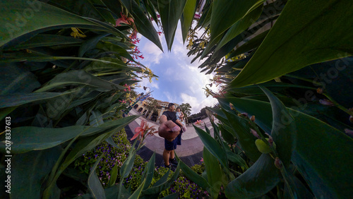 Father and daughter exploring tropical garden with unique perspective