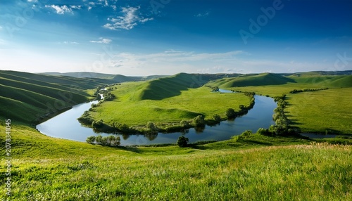 A Serene Landscape Featuring Rolling Green Hills And A Calm River
