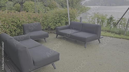 A video of a sofa in a hotel garden with a view of the sea