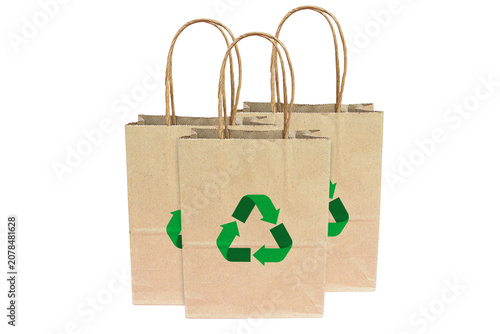 Eco-friendly paper shopping bag and recycling symbol on white background.