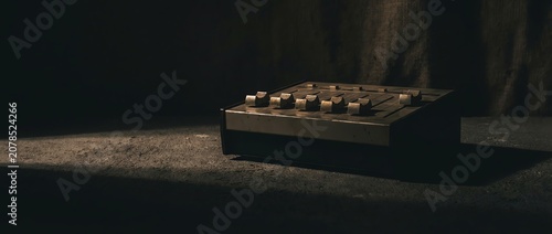 Dark room with spotlight on old synthesizer keyboard equipment