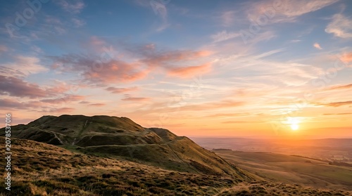 Golden sunset illuminating rolling hills and valleys