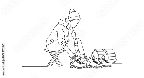 Person tying ski boots on snowy mountain slope.