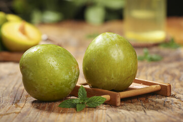 Fresh Green Plums on Wooden Board with Mint - Healthy Organic Fruit Studio Photography