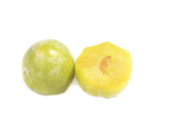 Fresh Yellow Green Plums Cut in Half Studio Shot on White Background